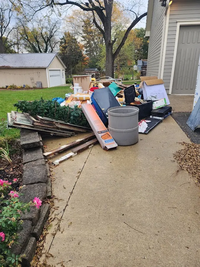 Dumpster being loaded with debris for Estate Cleanout Dumpster Rental in Dover